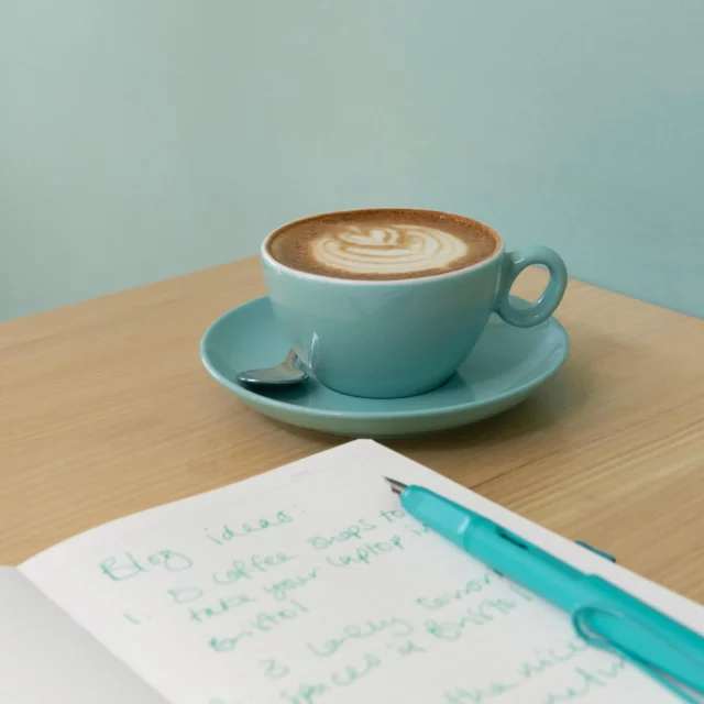 Tomato Tuesday Coworking - notebook and pen with a coffee